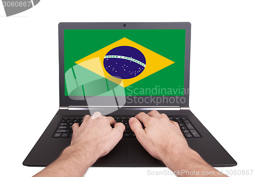 Image of Hands working on laptop, Brazil