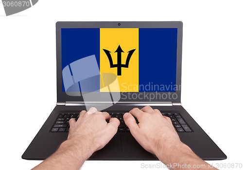 Image of Hands working on laptop, Barbados