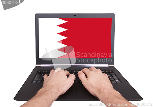 Image of Hands working on laptop, Bahrain