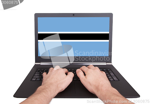 Image of Hands working on laptop, Botswana