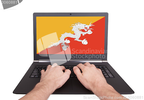 Image of Hands working on laptop, Bhutan