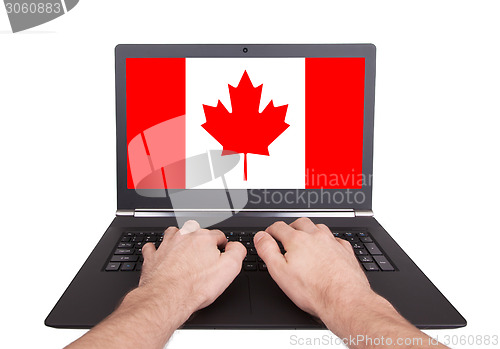 Image of Hands working on laptop, Canada