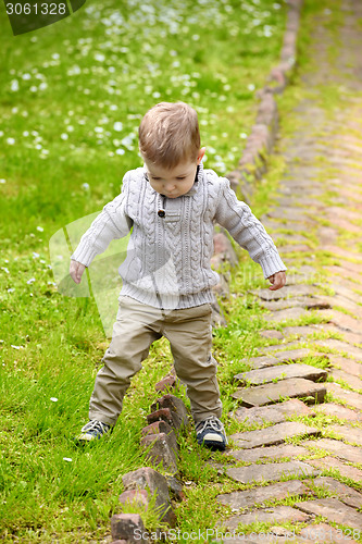 Image of Trendy 2 years old baby boy playing in park