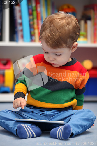 Image of Happy 2 years old boy using a digital tablet computer