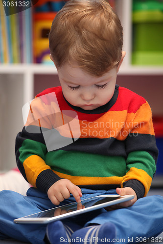 Image of Happy 2 years old boy using a digital tablet computer