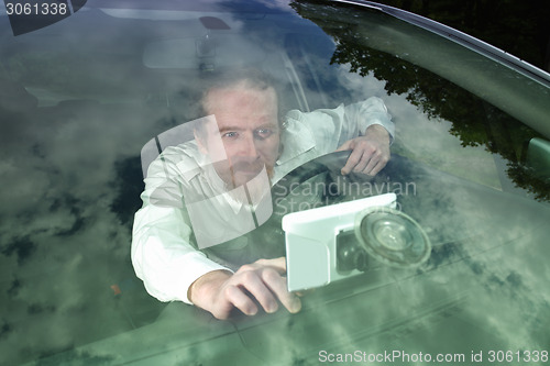 Image of Driver using  GPS navigation a way