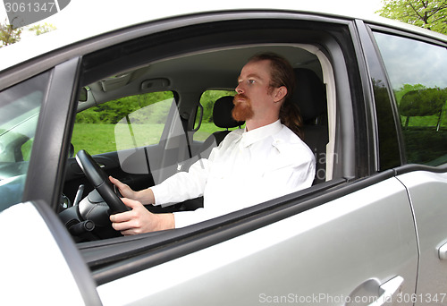 Image of Man driving his car on road