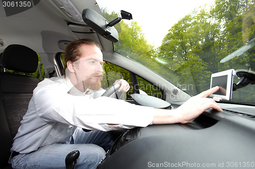 Image of Driver using  GPS navigation a way