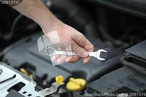 Image of Auto mechanic with iron spanners in closeup