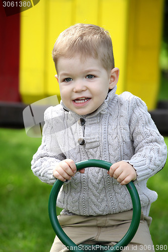 Image of 2 years old Baby boy on playground in spring outdoor park 