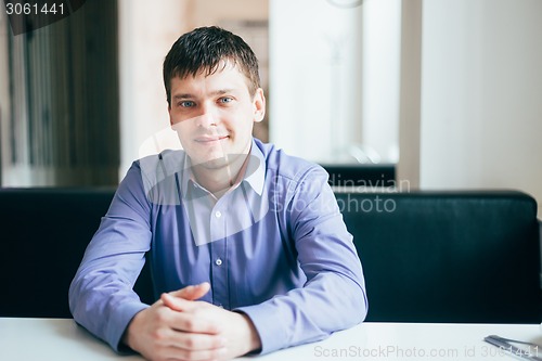 Image of Handsome Thinking Man In Shirt Sitting In Cafe