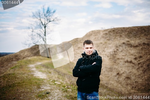 Image of Young Handsome Man Stayed In Field, Meadow In Autumn Day