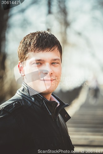 Image of Handsome man outdoors portrait. Autumn colors.