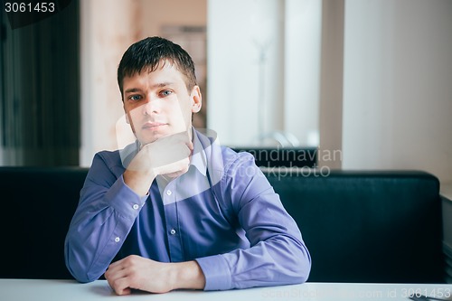 Image of Handsome Thinking Man In Shirt Sitting In Cafe