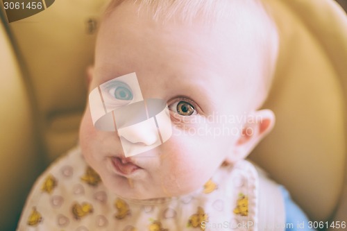 Image of Happy Curious Young Baby Boy Eating Porridge