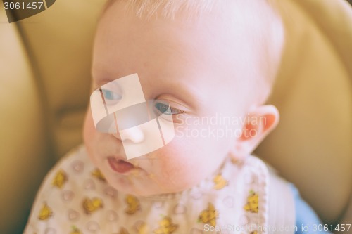 Image of Happy Curious Young Baby Boy Eating Porridge