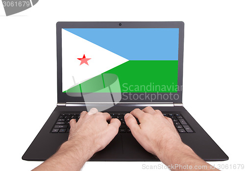 Image of Hands working on laptop, Djibouti