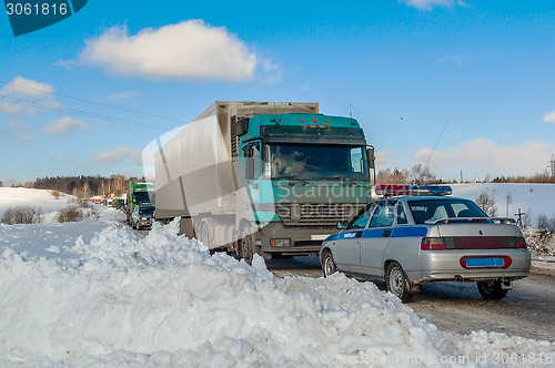 Image of Trucks stopped on highway after heavy snow storm