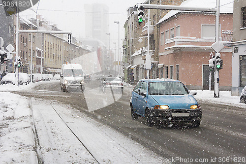 Image of Snowy winter road with cars driving