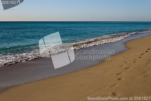 Image of Footsteps on a golden, sandy beach