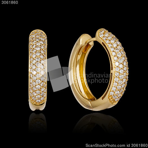 Image of Gold diamond earrings isolated on black background