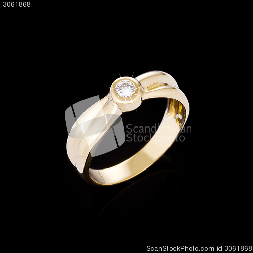 Image of Gold Diamond ring on black background 