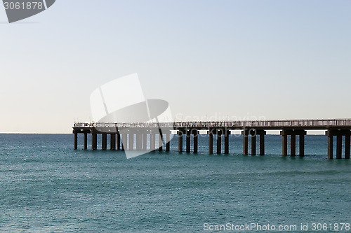 Image of Ocean fishing pier stretchs over calm seas