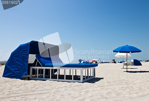 Image of Luxurious beach bed with canopy on a sandy beach