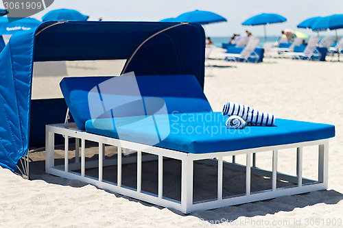 Image of Luxurious beach bed with canopy on a sandy beach