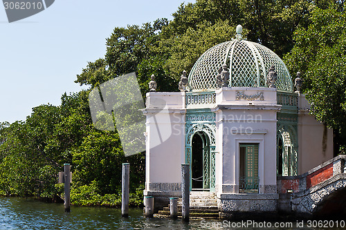 Image of Ornate waterfront building in a garden