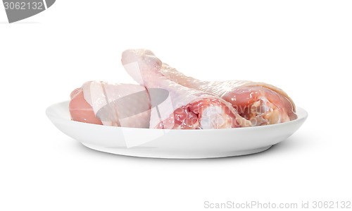 Image of Three Raw Chicken Legs On White Plate Rotated