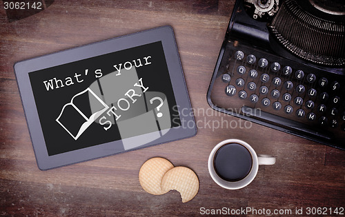 Image of Tablet touch computer gadget on wooden table, what's your story