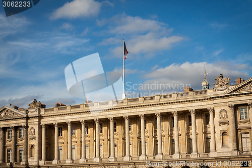 Image of Flag of France fluttering under a serene blue sky