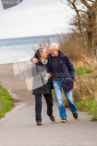 Image of happy mature couple relaxing baltic sea dunes 