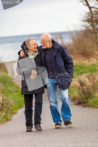 Image of happy mature couple relaxing baltic sea dunes 