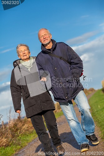 Image of happy mature couple relaxing baltic sea dunes 