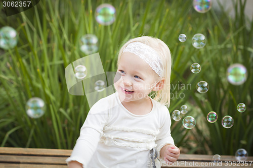 Image of Adorable Little Girl Having Fun With Bubbles