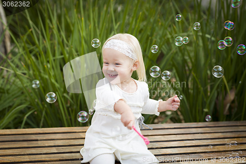 Image of Adorable Little Girl Having Fun With Bubbles