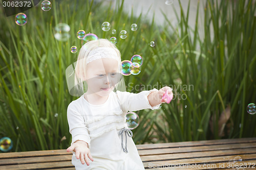 Image of Adorable Little Girl Having Fun With Bubbles