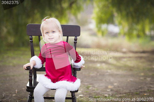 Image of Adorable Little Girl Sitting in Her Chair Outside