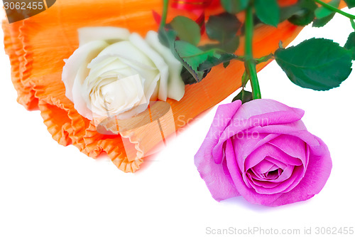 Image of Bouquet of roses in a beautiful package on a white background.