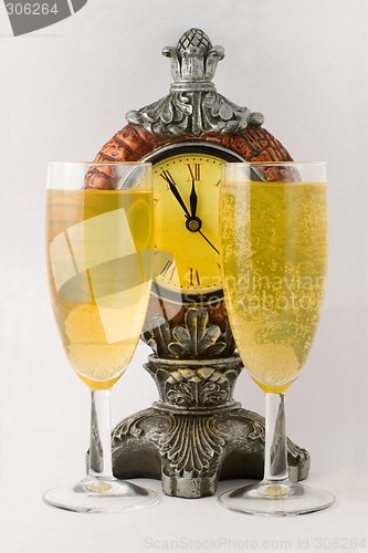 Image of Clock and two tall wine glass