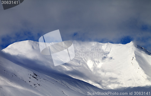 Image of View on sunlight off-piste slope in mist