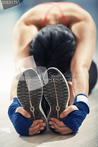 Image of Stretching woman in exercising room