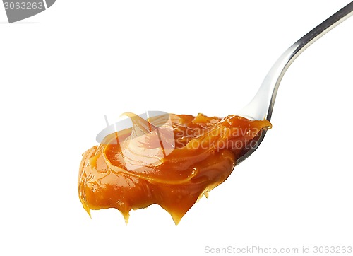Image of Spoon of melted caramel cream