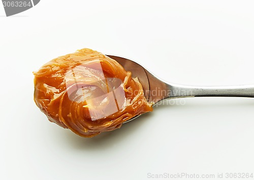 Image of Spoon of melted caramel cream