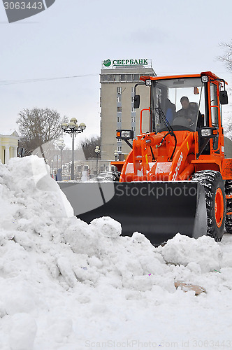 Image of The bulldozer occupied with snow cleaning costs on the street in