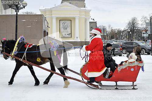 Image of Festive drivings on sledge with Father Frost.