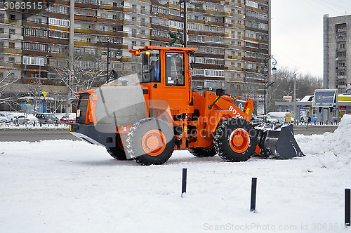 Image of The bulldozer occupied with snow cleaning costs on the street in