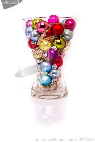 Image of Christmas baubles with lights in a vase